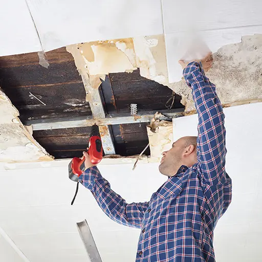 Man repairing collapsed ceiling